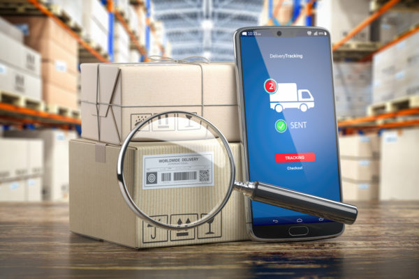 Smartphone With Cardboard Boxes And Loupe
